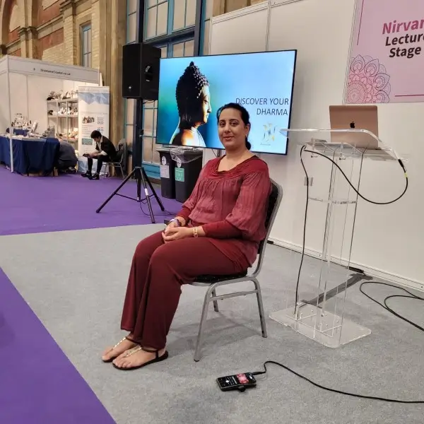 Nikita Thakrar sitting on stage during her Dharma workshop talk