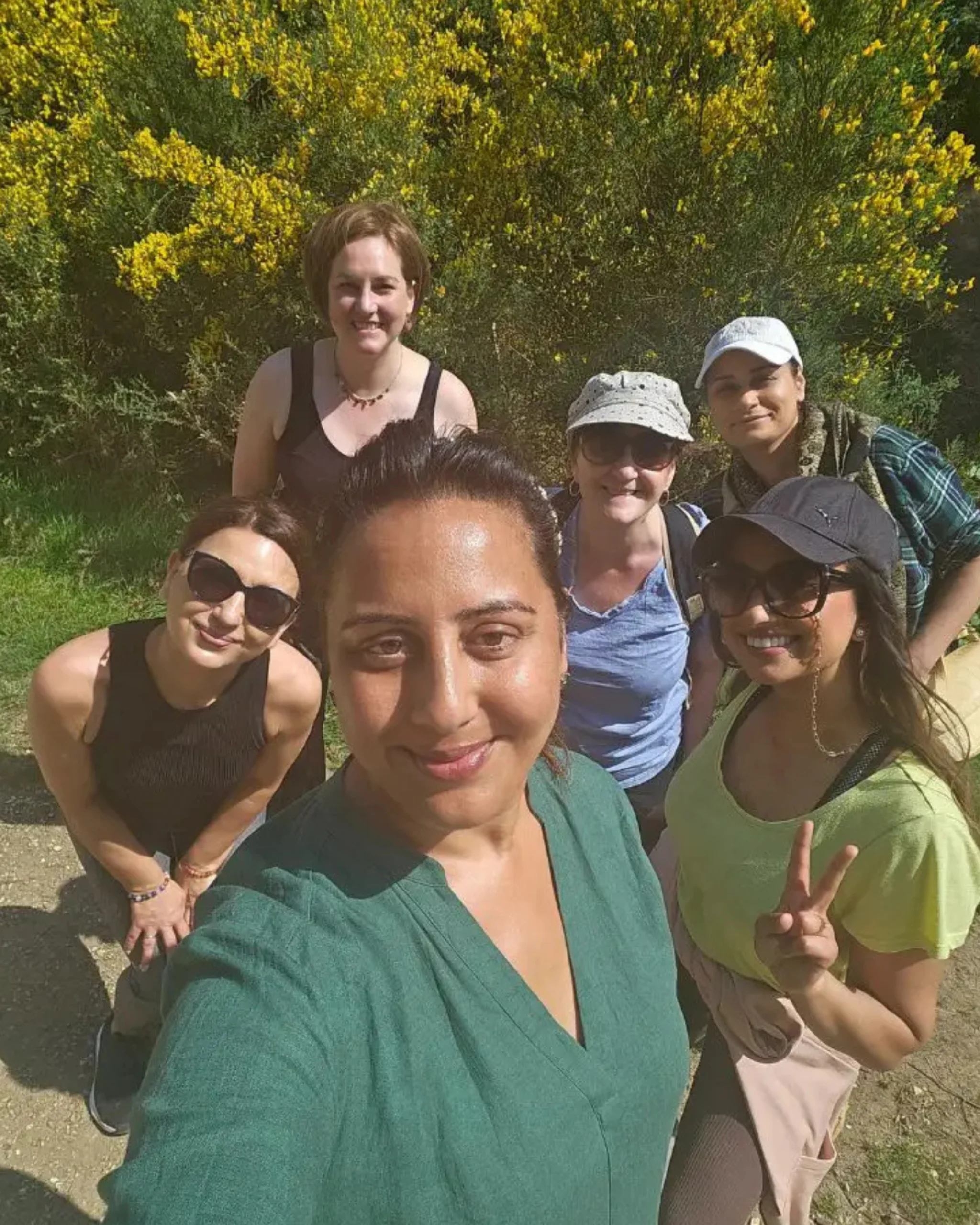Group selfie of smiling participants and retreat facilitator during the Forest Retreat in Berkshire, UK, capturing a joyful moment of connection and community