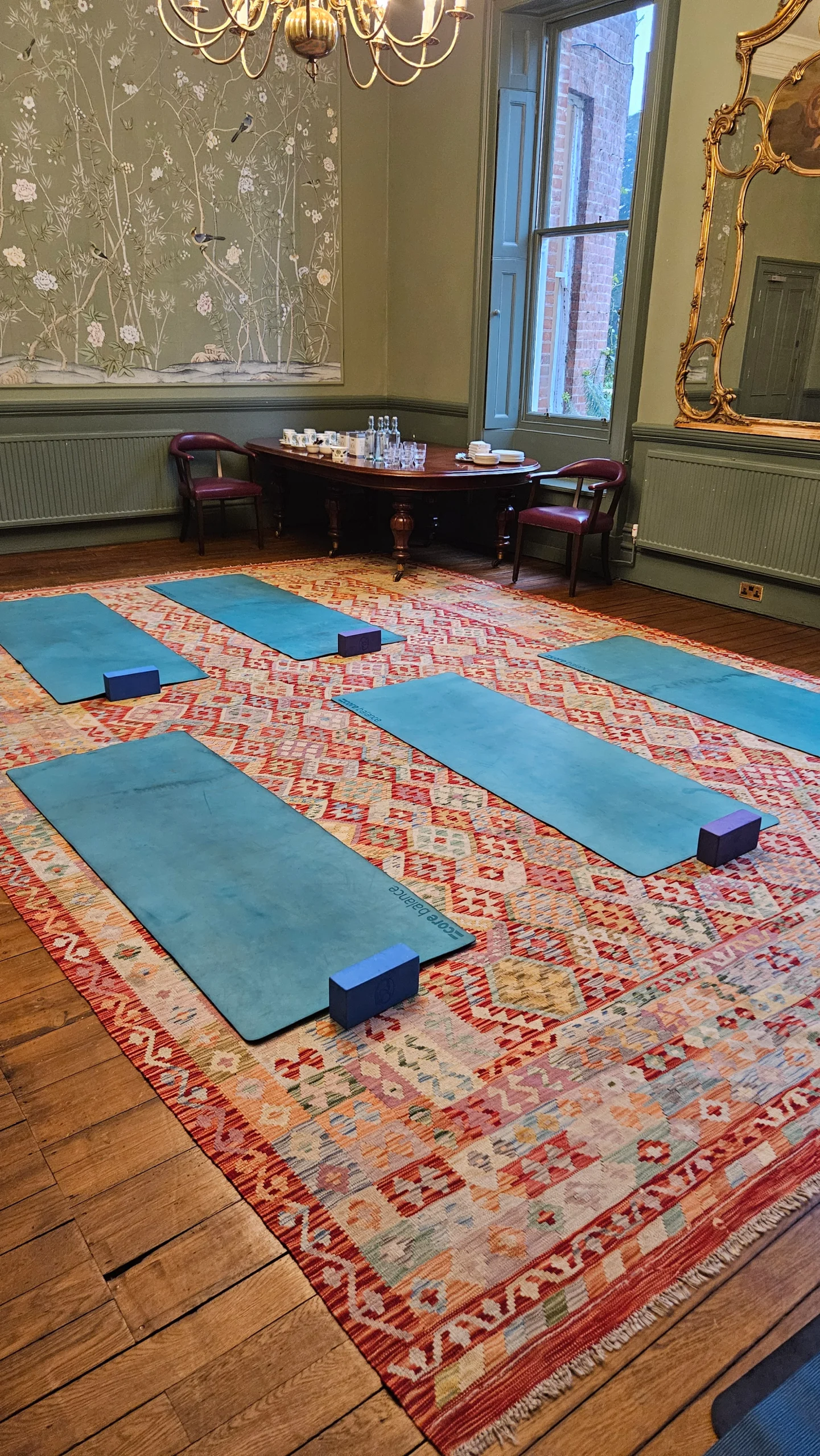 Peaceful indoor yoga and meditation space prepared for a boutique wellness retreat in Berkshire, UK, featuring soft lighting, cushions, and calming decor