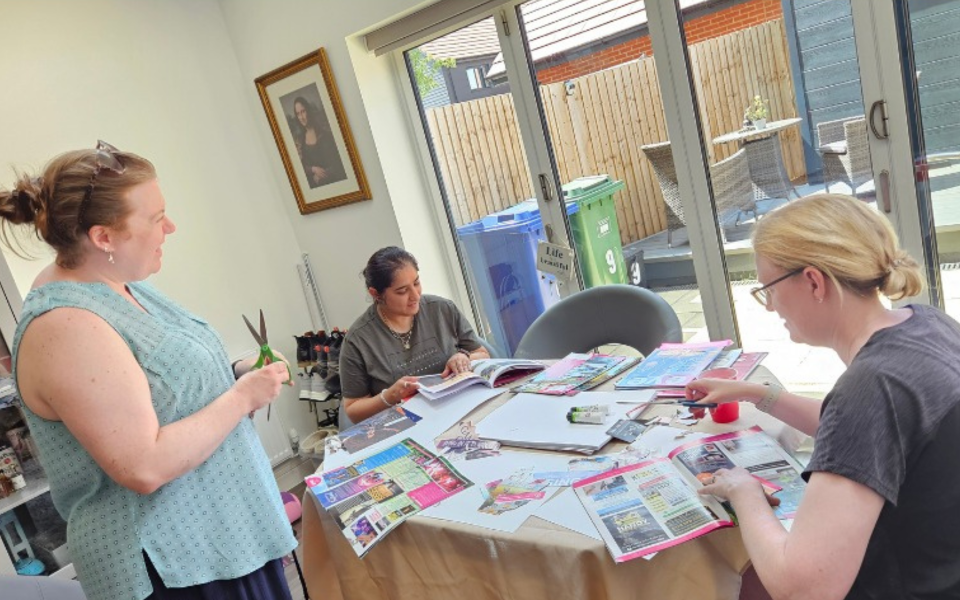 Participants proudly displaying their completed vision boards during the Forest Retreat by Nikita Thakrar in Berkshire, sharing their personal growth insights.